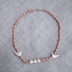 Vintage handmade necklace from 1980s. Made of various wood beads and metal seed